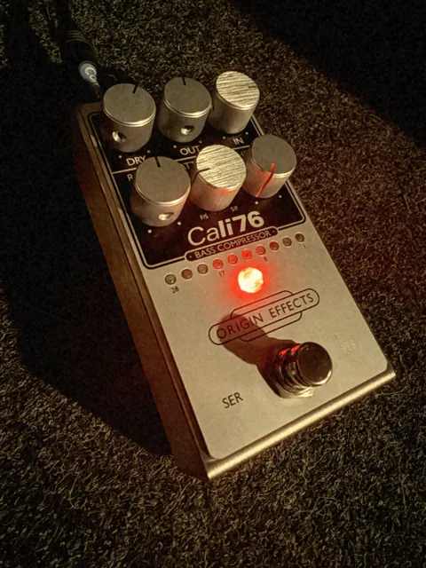 Origin Effects Cali76 bass compressor pedal with a glowing red LED